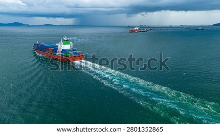 Cargo container ship sailing through the ocean under a dark stormy sky with rain clouds. Concept of global supply chain risk, maritime logistics crisis, and adverse weather navigation.