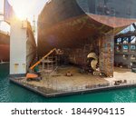 Cargo container ship stern with propeller at drydock for maintenance follow annual plan and service.