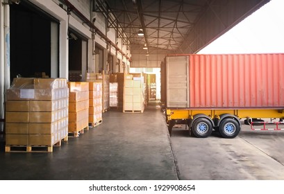 Cargo Container, Trailer Truck Parked Loading Package Boxes at Dock Warehouse. Cargo Shipment. Industry Freight Truck Transportation. Shipping Warehousing Logistics.