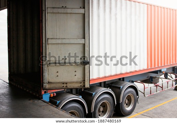Cargo\
container truck loading at dock warehouse. Trailer docking\
stations. Industry freight truck\
transport.