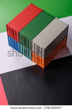 Cargo containers on the UAE flag as a conceptual backdrop for goods export and logistics. Cargo containers on the UAE flag as a background for your design