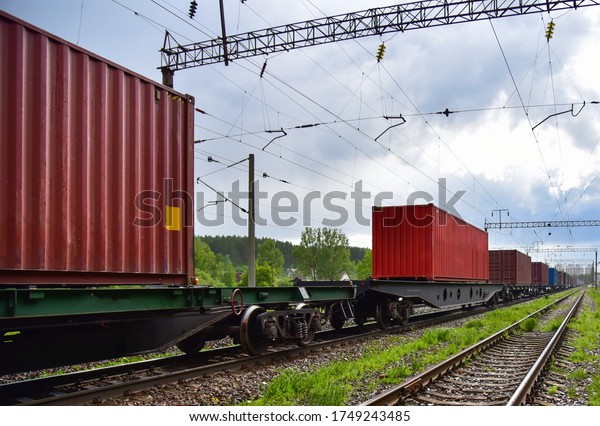 Cargo Containers Transportation On Freight\
Train By Railway. Intermodal Container On Train Car. Rail Freight\
Shipping Logistics Concept. Import - export goods from Сhina.\
Global economy in\
recession