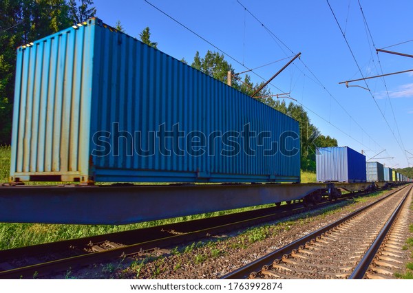 Cargo Containers Transportation On Freight\
Train By Railway. Intermodal Container On Train Car. Rail Freight\
Shipping Logistics. Import - export goods from Сhina. Soft focus,\
possible granularity