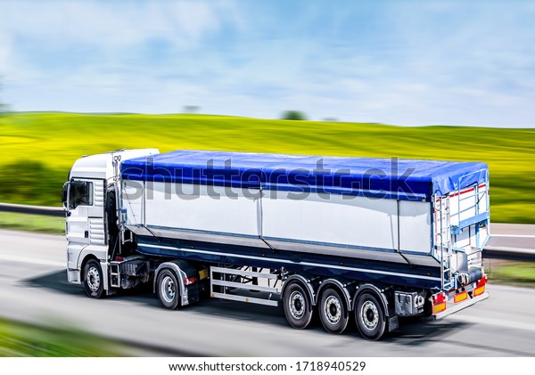 Cargo delivery, agriculture.Truck moves on the\
road at speed, delivery of\
goods.