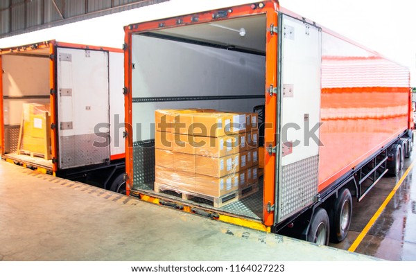 Cargo freight truck. Shipment, Delivery service.\
Logistics and transportation. Warehouse dock load pallet goods into\
shipping container truck. Stacked package boxes on pallet inside a\
truck.