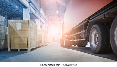 Cargo Freight Trucks Transport Logistics. Trailer Container Truck Parked Loading Package Boxes at the Warehouse. Supply Chain Delivery Distribution Warehouse Center. Shipping Truck Shipment Cargo.