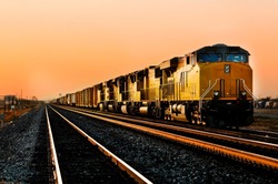 Cargo Locomotive Railroad Engine Crossing Arizona Desert Wilderness During Sunset