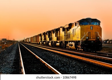 Cargo Locomotive Railroad Engine Crossing Arizona Desert Wilderness During Sunset