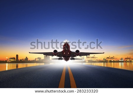 cargo plane take off from airport runways against ship port background use for air transportation and cargo logistic industry ,import ,export business 