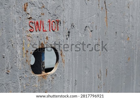 A cargo securing strong point integrated into the main deck bulwark of an offshore support vessel. The bulwark separates the cargo deck from the designated safe passage area and provides protection for personnel moving around the vessel. The strong point is marked with a Safe Working Load (SWL) of 10 tones and is used for securing cargo on the main deck during offshore transportation operations.