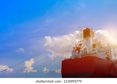 Cargo Ship Closeup Stern With Exhaust Gas Pipe And Safety Lifeboat On Blue Sky Background