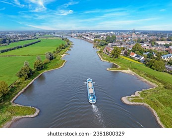 Cargo ship cruising on the river IJssel near Zutphen in the Netherlands