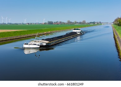 Cargo ship loaded with coal on the canal in Wesermarsch near Balge
