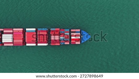 Cargo ship navigating through the open ocean, freight containers stacked on deck, illustrating global logistics, international trade, and marine transportation from a top down aerial perspective