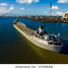 A Cargo Ship On The Great Lakes Is Pulling Into Port To Unload Its Products For Distribution To The Community.