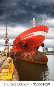 Cargo Ship In Port At Cloudy Day.