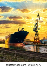 Cargo Ship And The Port At Sunset.