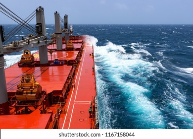 Cargo Ship Rolling In Stormy Sea. Huge Waves Under Blue Sky In Indian Ocean