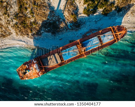 Cargo ship run aground at sea coastline near Novorossiysk and Gelendzhik. Shipwreck accident of nautical vessel after huge sea storm, aerial view from drone