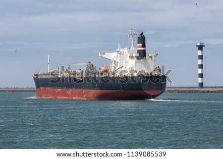 Cargo ship sailing out of Dutch harbor Rotterdam, biggest seaport of Europe
