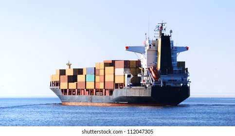 Cargo Ship Sailing In Still Water