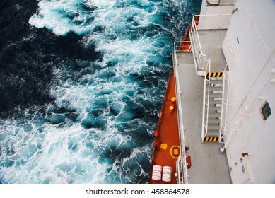 Cargo Ship At Sea During A Storm. Part Of The Deck And The Sea Depths.