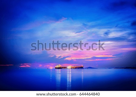 cargo ship in sea loading and unloading  on seascape sky blue soft light