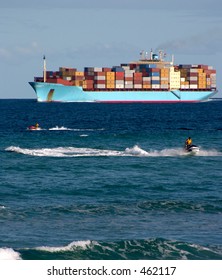 Cargo Ship With Two Jetski Riders In Front