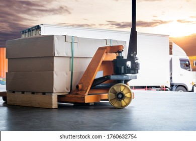 Cargo shipment loading for truck. Large shipments pallet goods with hand pallet truck waiting for load into a truck. Road freight cargo industry. Logistics and transportation.