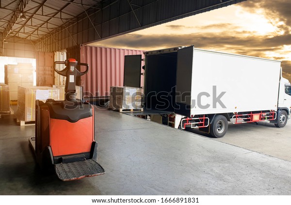 Cargo shipment loading for truck.Truck\
container docking load shipment goods at warehouse, forklift pallet\
jack with stack package boxes on pallet. Road freight truck\
delivery logistics and\
transport.