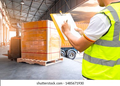 Cargo shipment loading for truck.Worker holding clipboard, his inspecting document with cargo. Forklift pallet jack with pallet goods. Freight truck, Shipping warehouse, Logistics and transport.