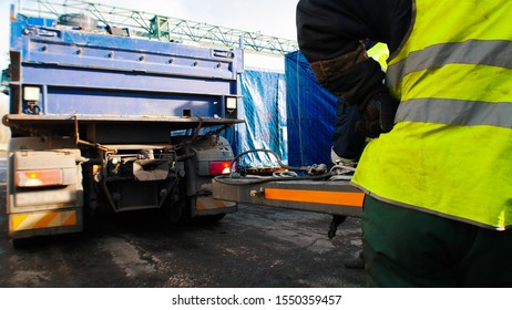 Cargo Shipping -a Man Worker In Protective Reflex Vest Standing On The Site