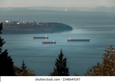 Cargo Ships Anchored In Burrard Inlet Near Point Grey In Vancouver, BC.