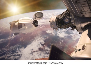 Cargo spacecraft in low-Earth orbit with sunlight. Elements of this image furnished by NASA. - Shutterstock ID 1996260917