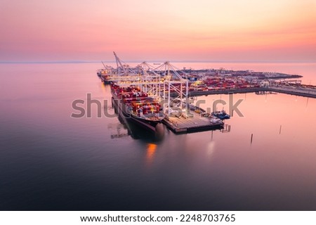 Cargo terminal loading shipping containers onto cargo ships, aerial footage, hyperlapse, Vancouver, BC, Canada, marine terminal, cargo crane.