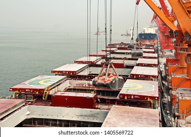 Cargo terminal for unloading grain cargo and containers by shore cranes. Port Guangzhou, China. February, 2019.