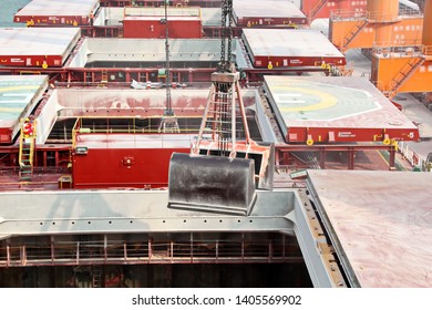 Cargo terminal for unloading grain cargo and containers by shore cranes. Port Guangzhou, China. February, 2019.
