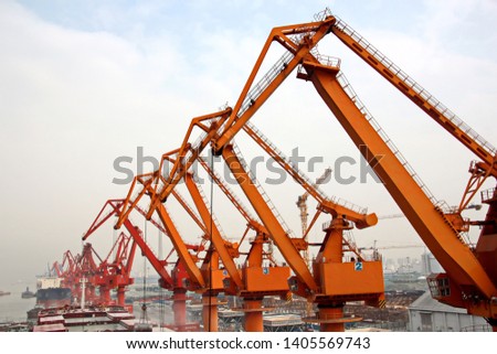 Cargo terminal for unloading grain cargo and containers by shore cranes. Port Guangzhou, China. February, 2019.