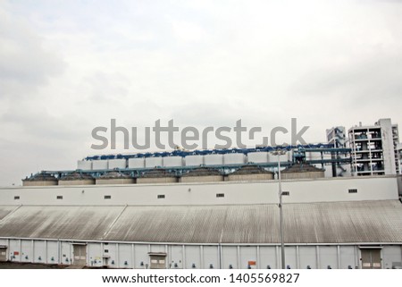 Cargo terminal for unloading grain cargo and containers by shore cranes. Port Guangzhou, China. February, 2019.