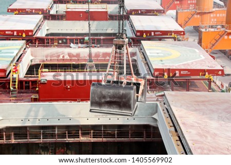 Cargo terminal for unloading grain cargo and containers by shore cranes. Port Guangzhou, China. February, 2019.