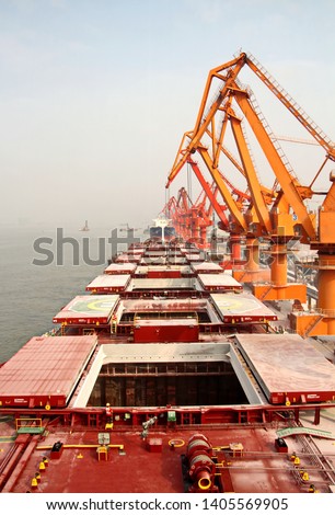 Cargo terminal for unloading grain cargo and containers by shore cranes. Port Guangzhou, China. February, 2019.