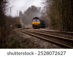 Cargo train driving down a train track 