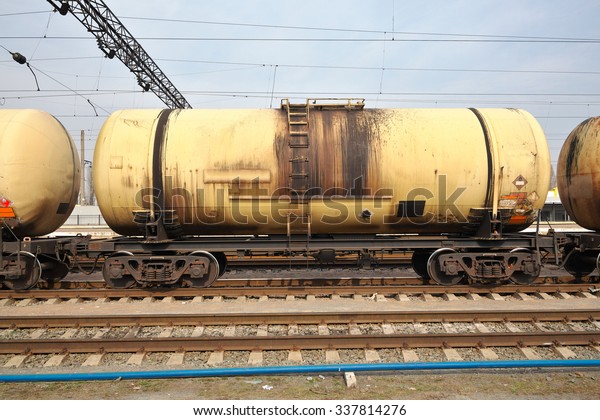 Cargo train\
with oil cars on the railway\
station
