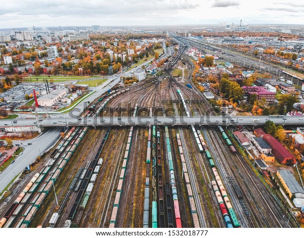 Cargo trains. Aerial view of colorful freight\
trains on the railway station. Wagons with goods on railroad. Heavy\
industry. Industrial conceptual scene with trains. View from flying\
drone.