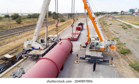 Cargo Transportation. Transportation Of Oversized Cargo.Two Truck Cranes Load An Oversized Cistern Onto A Transport Truck. Shymkent, Kazakhstan - September 26 2021