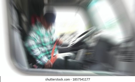 Cargo Truck Driver Is Fastening Seat Belt While On Duty.blurry View Perspective