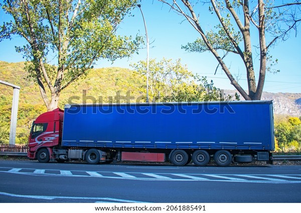 Cargo truck. Haulling. Truck stopped on the side\
of the road. High costs and the crisis of carriers - concept.\
Romania, Herculane. October, 20,\
2021