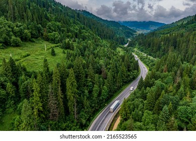 cargo truck on the higthway. cargo delivery driving on asphalt road through the mountains. seen from the air. Aerial view landscape. drone photography.  - Shutterstock ID 2165523565