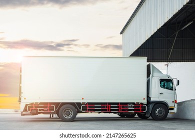 Cargo Trucks Parked At Warehouse With Sunset Sky. Shipping Container Trucks Freight Distribution. Lorry. Truck Transport Logistics.