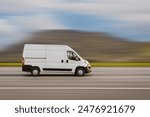 Cargo van is driving on the highway at speed with a blurred background. Freight transport, commercial transport concept with free space for text, copy space.